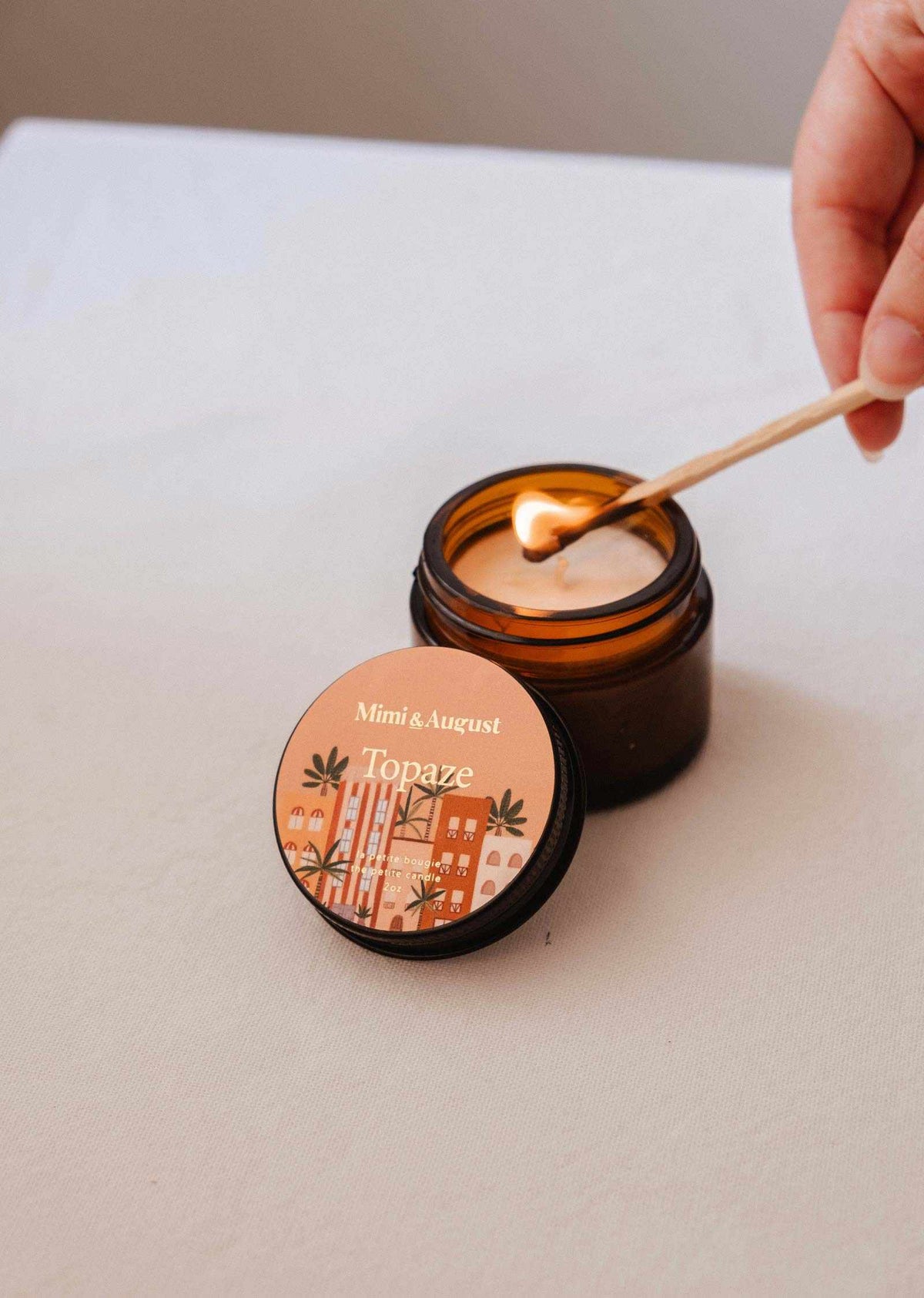 Mini Topaze soy candle by Mimi & August in a 2 oz glass jar, featuring a warm, inviting design with a natural wick.