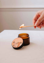 Mini Topaze soy candle by Mimi & August in a 2 oz glass jar, featuring a smooth, natural-colored candle with a wooden wick.