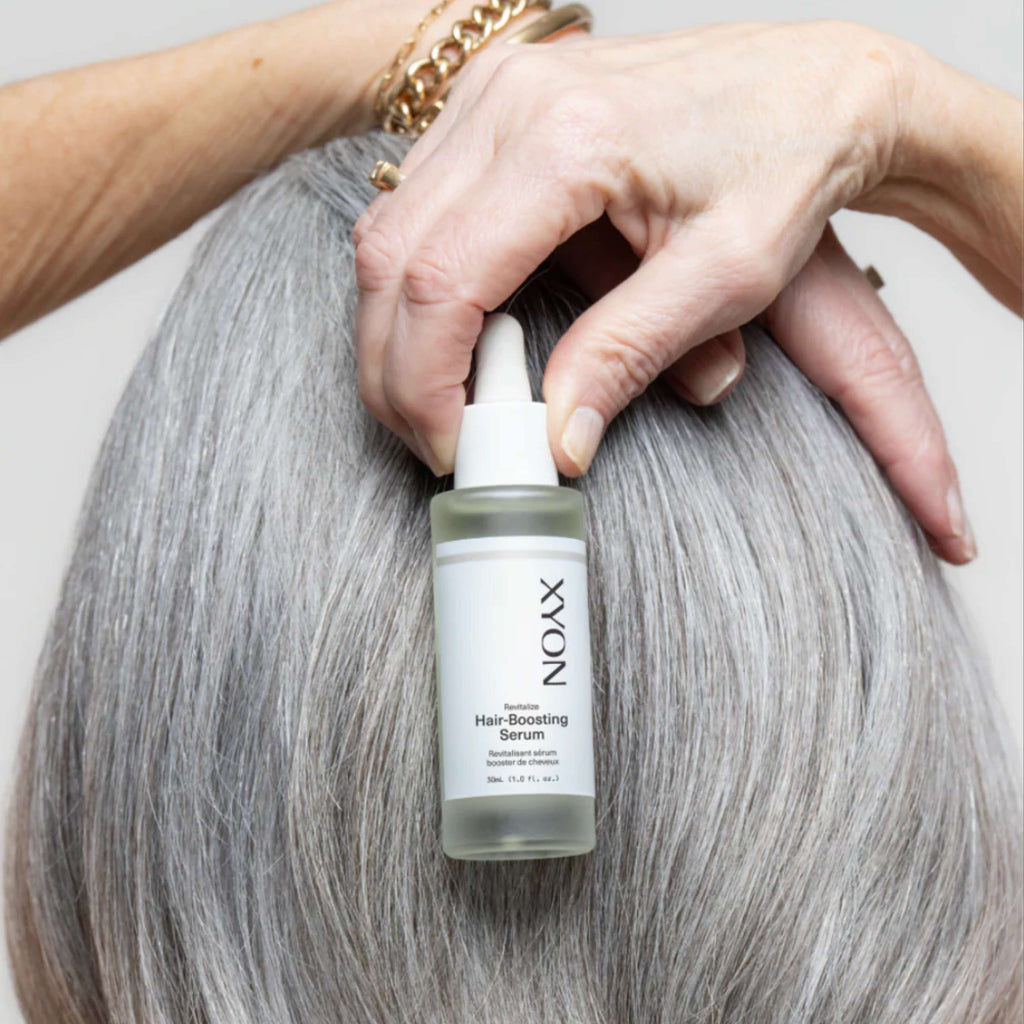 XYON Revitalize hair-boosting serum for women, featuring a sleek bottle with a dropper, designed to strengthen and repair hair.