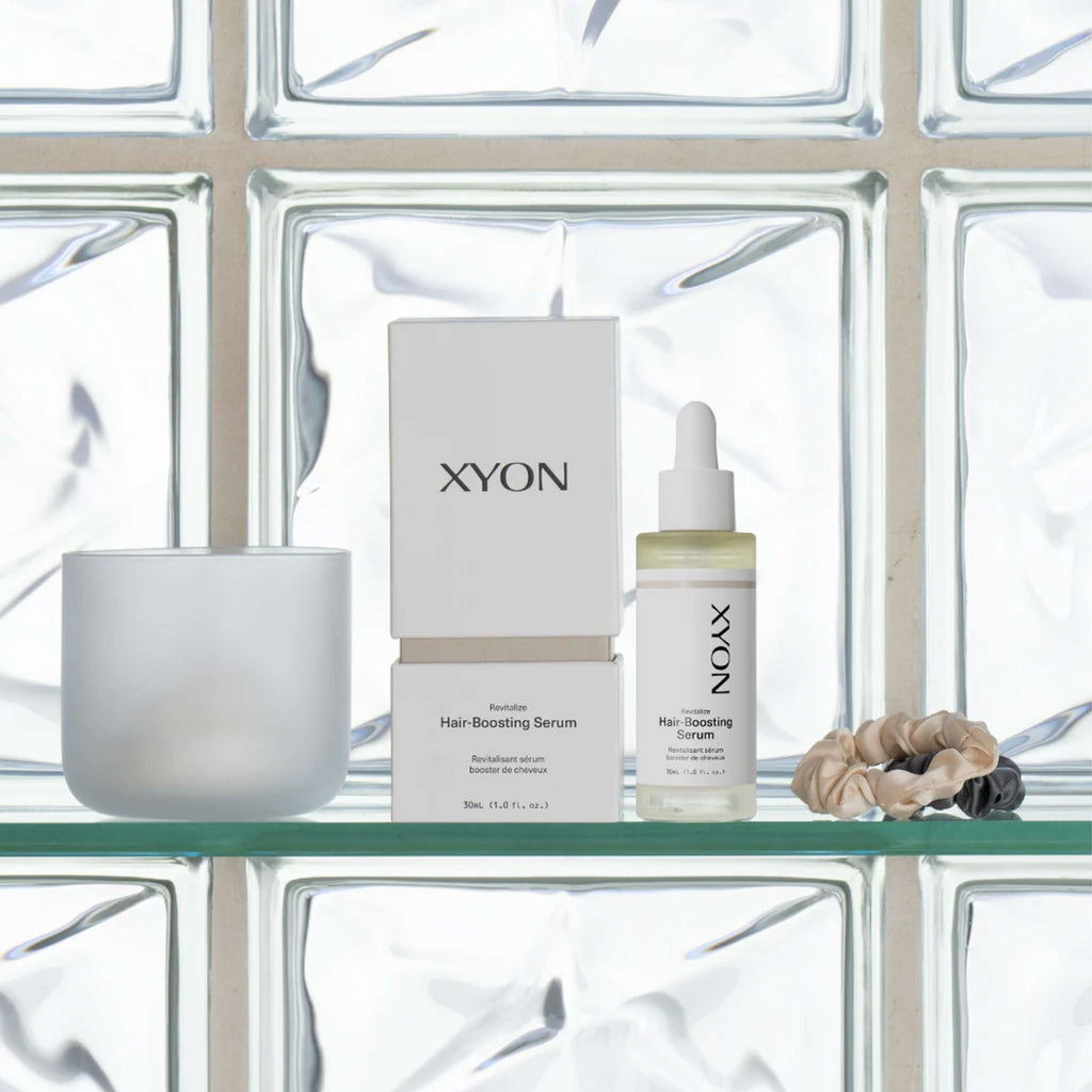 XYON Revitalize Hair-Boosting Serum for Women by wedoskin, featuring a sleek bottle and dropper for hair repair treatment.