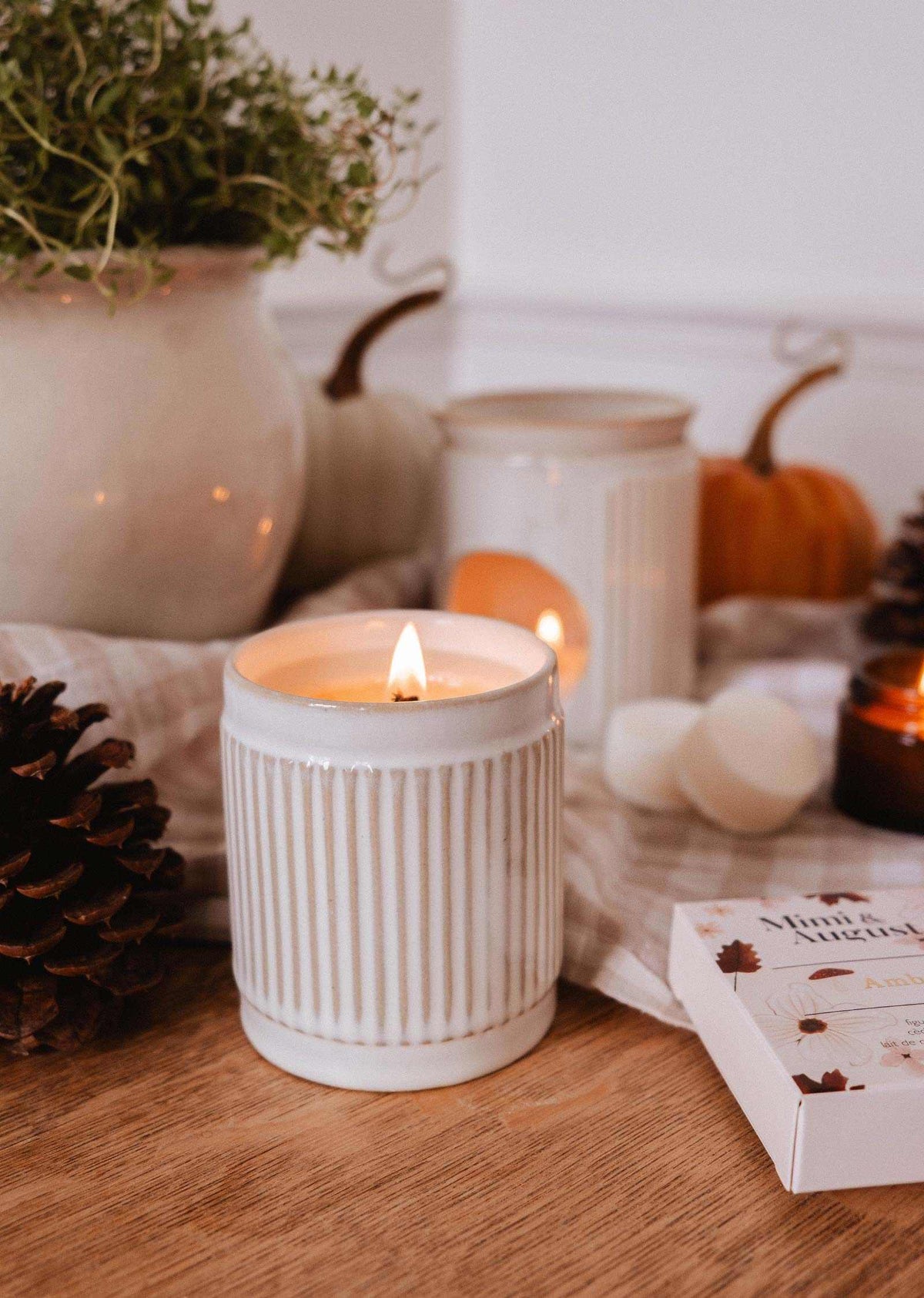 Amber scented reusable soy candle in a glass jar, decorative home decor piece by Mimi & August.
