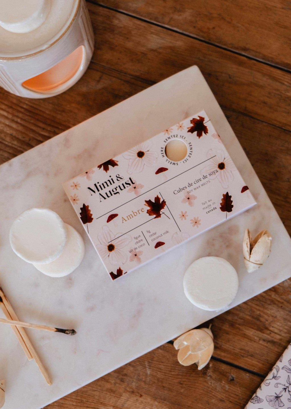 Soy wax melts in Ambre scent by Mimi & August, showcasing a set of golden wax tarts with warm, amber fragrance.