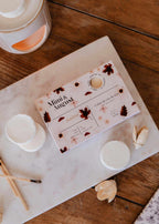 Soy wax melts in Ambre scent by Mimi & August, showcasing a set of golden wax tarts with warm, amber fragrance.