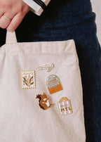Colorful Bagel MTL enamel pin by Mimi & August featuring Montreal-inspired design, perfect for accessories or jackets.