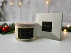 The InnerCandescent Co Sacred Hearth luxury candle with warm spiced Christmas scent and coconut apricot wax, placed beside its decorative box.