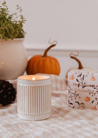 Decorative reusable soy candle shaped like a pumpkin from Mimi & August, ideal for home decor.