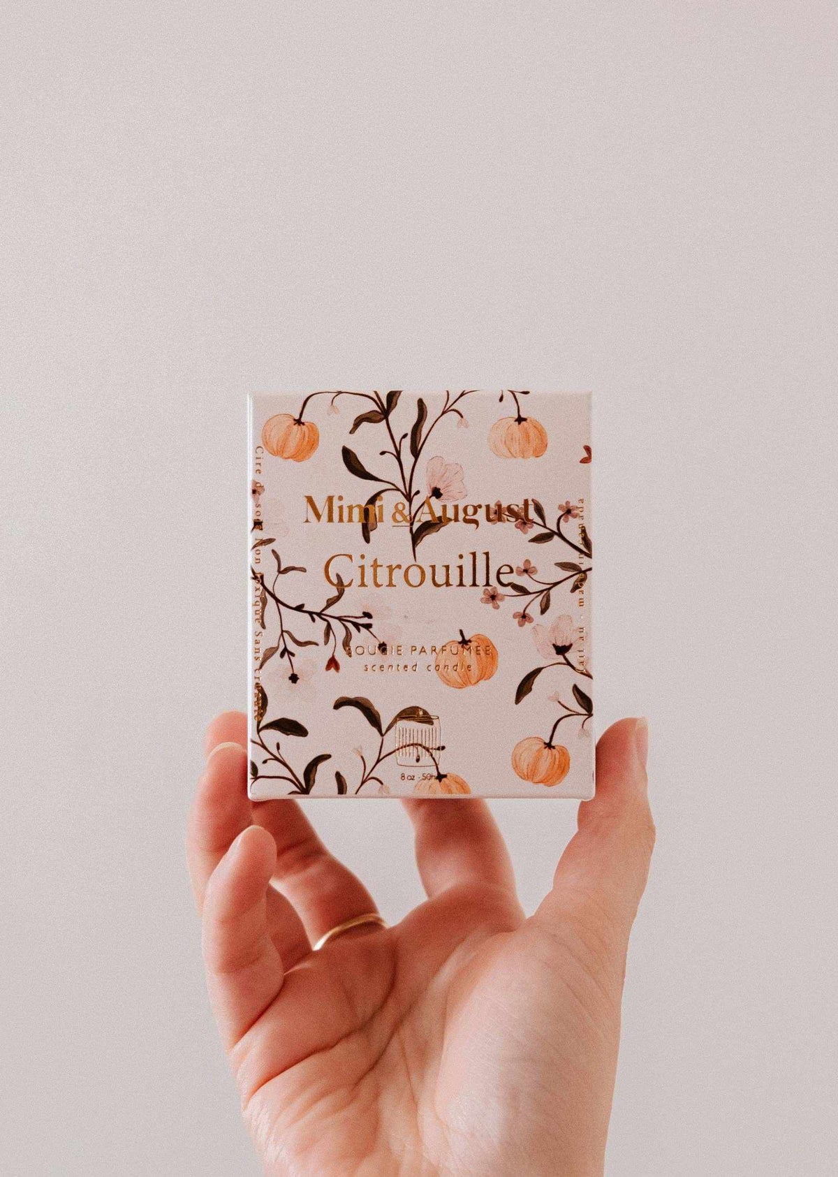 Reusable soy candle in a charming pumpkin-shaped container by Mimi & August, perfect for home decor.