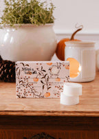 Soy wax melts in pumpkin scent by Mimi & August, featuring a close-up of the Citrouille wax tart with autumn-themed packaging.