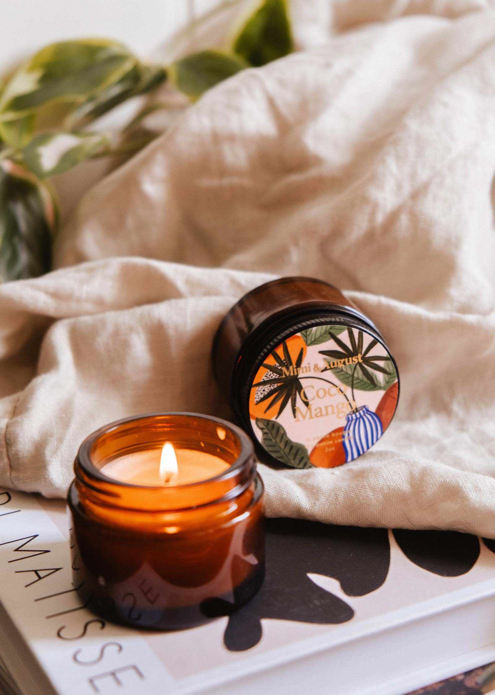 Mini Coco Mango soy candle by Mimi & August in a 2 oz container, featuring a tropical mango and coconut scent.