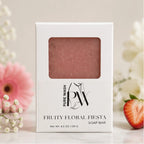 Handmade Fruity Floral Fiesta soap bar by Pure Wash with pink speckles and floral design on a white background.
