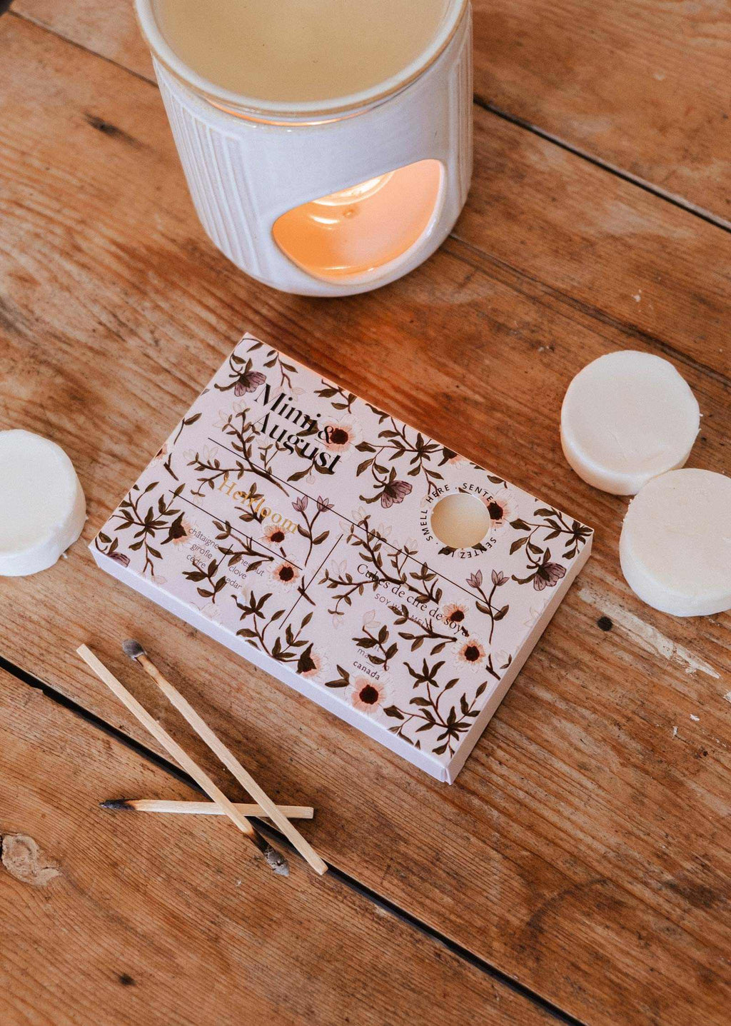 Soy wax melts in heirloom-inspired tart shapes by Mimi & August, featuring warm, natural tones and a smooth, fragrant surface.