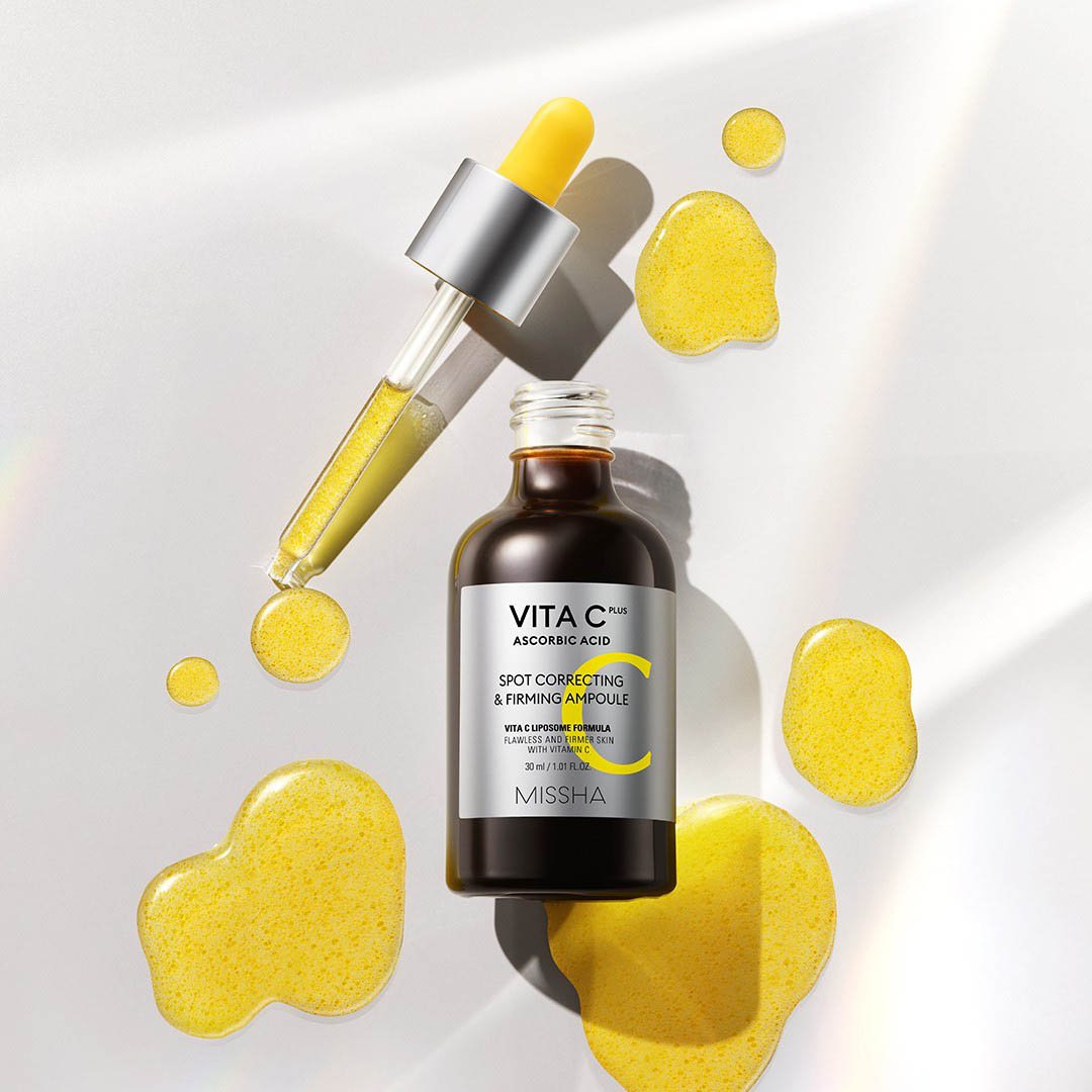 MISSHA Vita C Plus Spot Correcting and Firming Ampoule 30ml, clear glass bottle with dropper, displaying bright orange liquid.