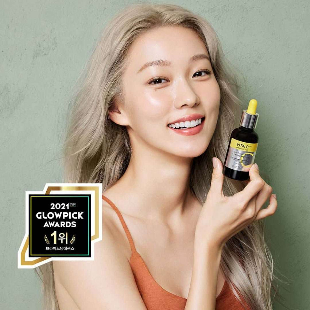 MISSHA Vita C Plus Spot Correcting & Firming Ampoule 30ml in a clear glass bottle with a white and orange label, displayed against a white background.
