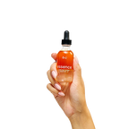 Peach and Cream® restorative body oil bath oil with a clear glass bottle and golden oil, ideal for nourishing skin during bath time.
