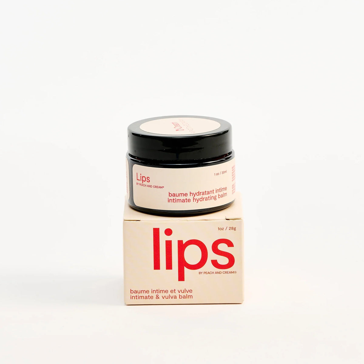 Peach and Cream vulva balm for lips in a compact jar with the product packaging visible.