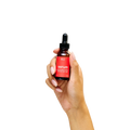 Peach and Cream arousal tonic serum in a sleek bottle, showing the clear gel formula and elegant packaging.