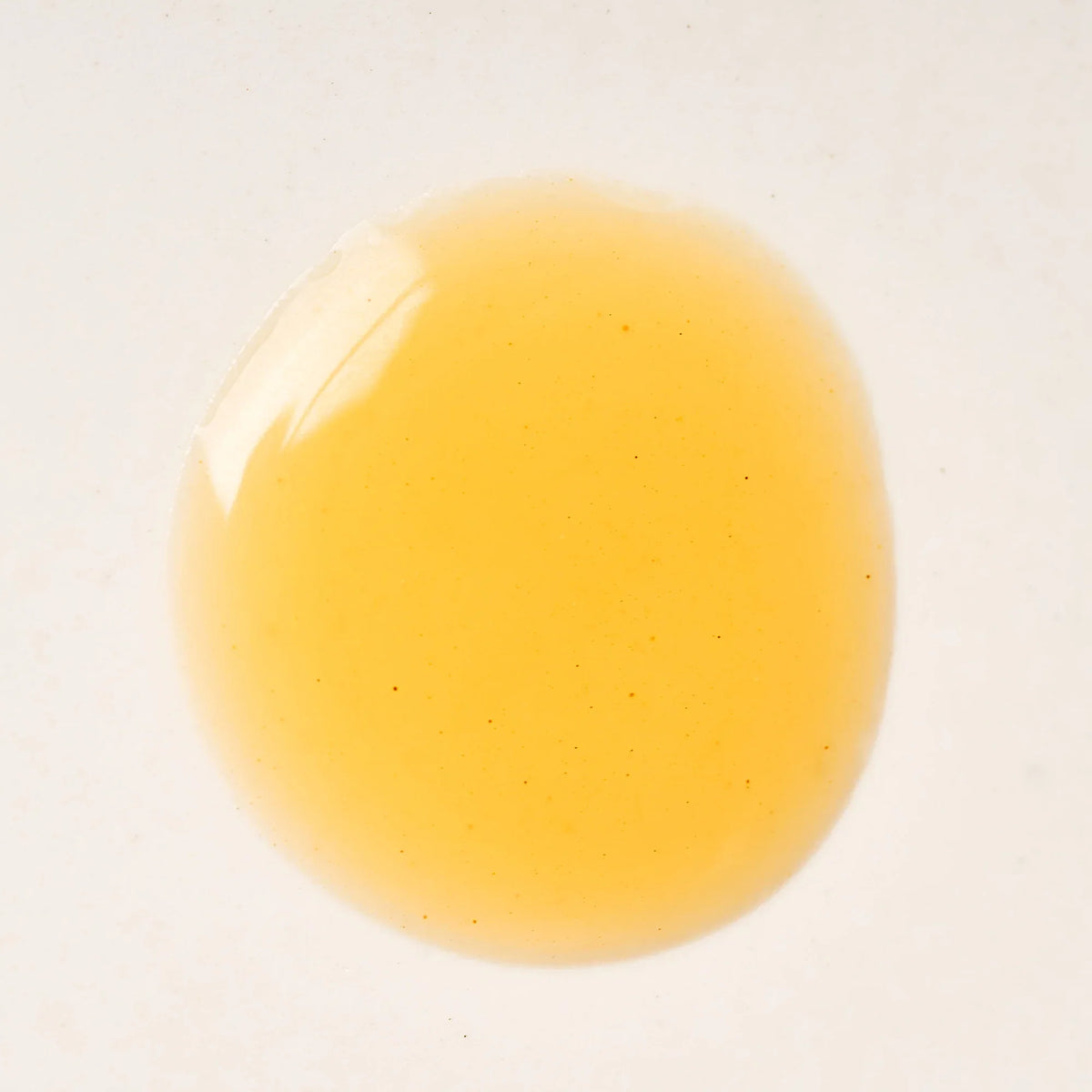 Peach and Cream arousal tonic serum with gel texture, featuring a sleek bottle and applicator for intimate wellness.