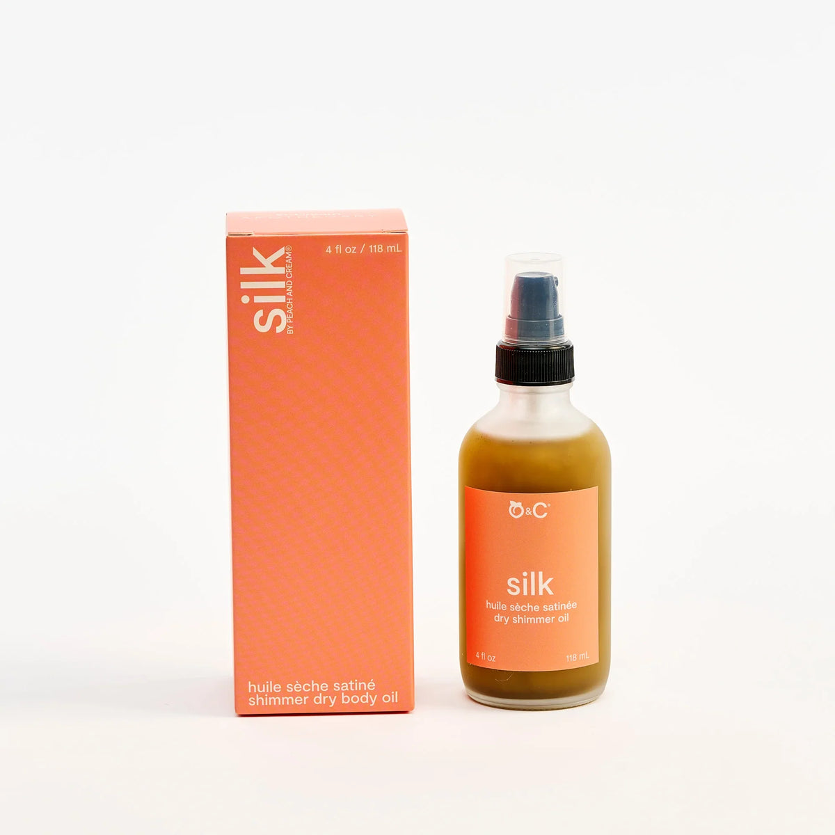 Peach and Cream Silk shimmer dry body oil bottle with elegant packaging, showcasing a luxurious body oil for glowing skin.