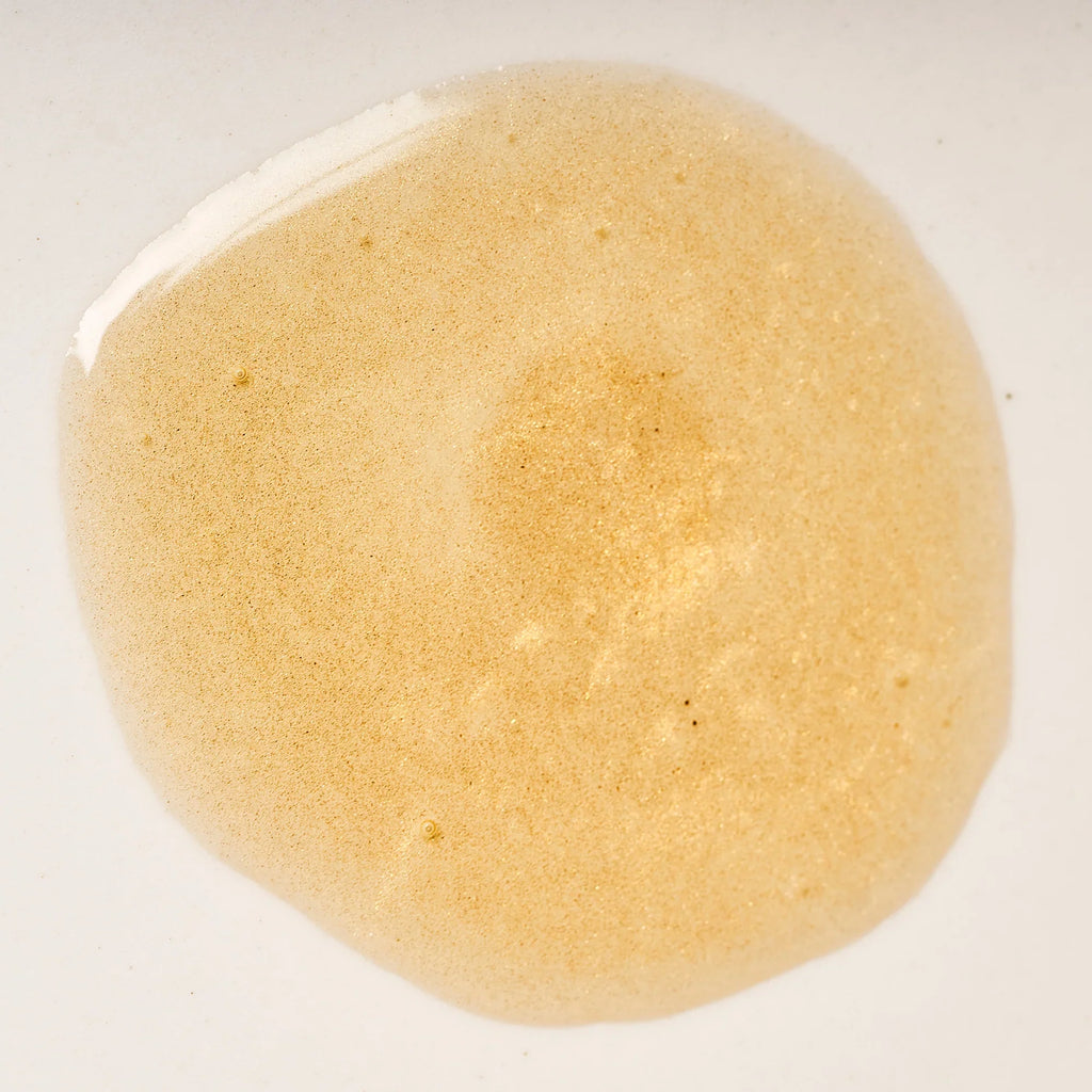 Peach and Cream Silk shimmer dry body oil with a smooth, glossy texture and a luxurious finish on skin.