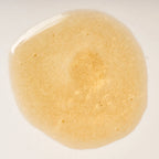 Peach and Cream Silk shimmer dry body oil with a smooth, glossy texture and a luxurious finish on skin.