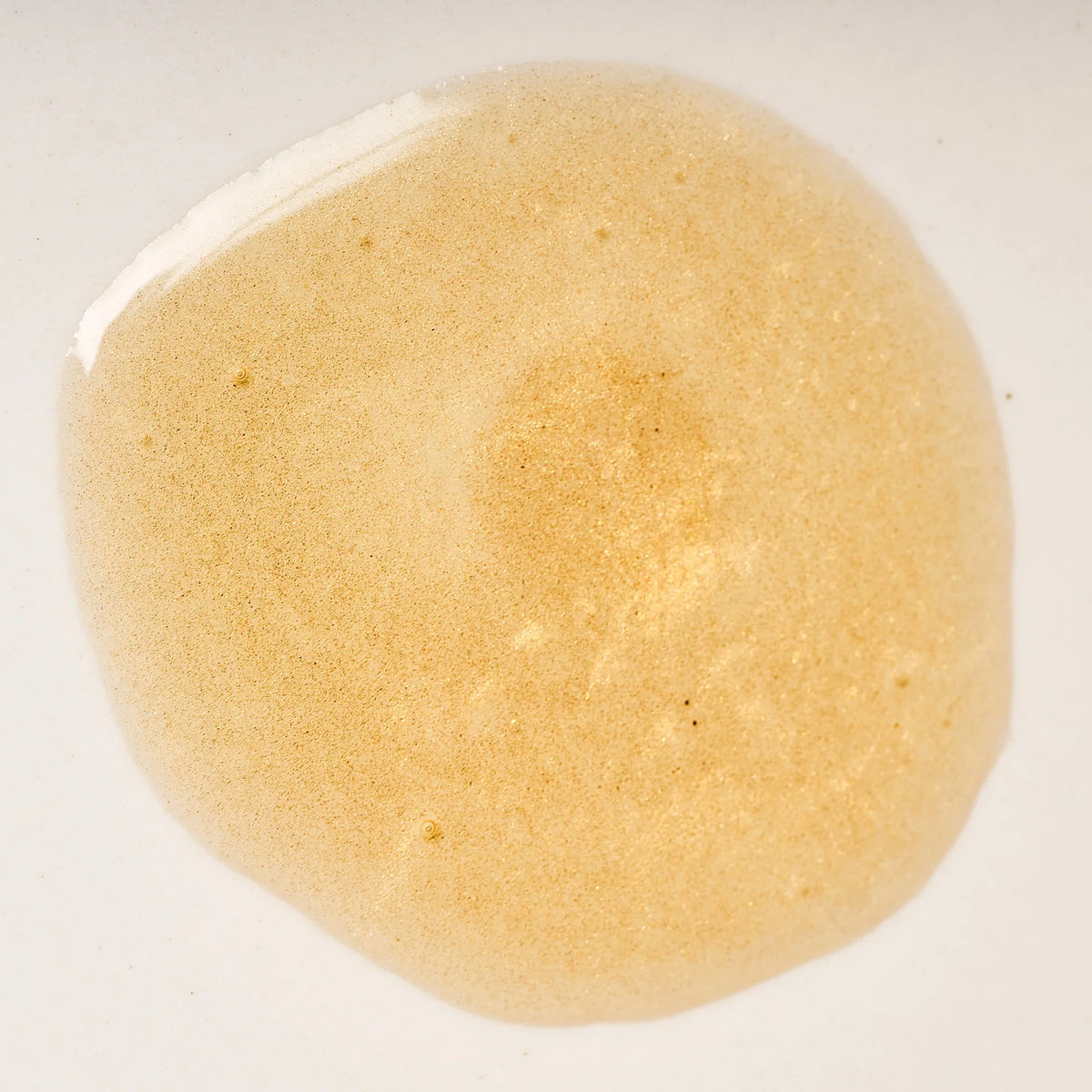 Peach and Cream Silk shimmer dry body oil with a smooth, glossy texture and a luxurious finish on skin.