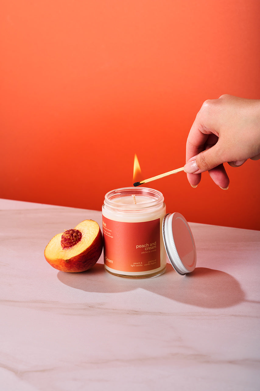 Peach and Cream massage candle melt in a glass container, featuring a soft, creamy texture and a peach-colored appearance.