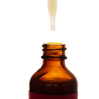 Peach and Cream arousal tonic serum bottle with dropper, pink and white packaging, designed for intimate wellness.