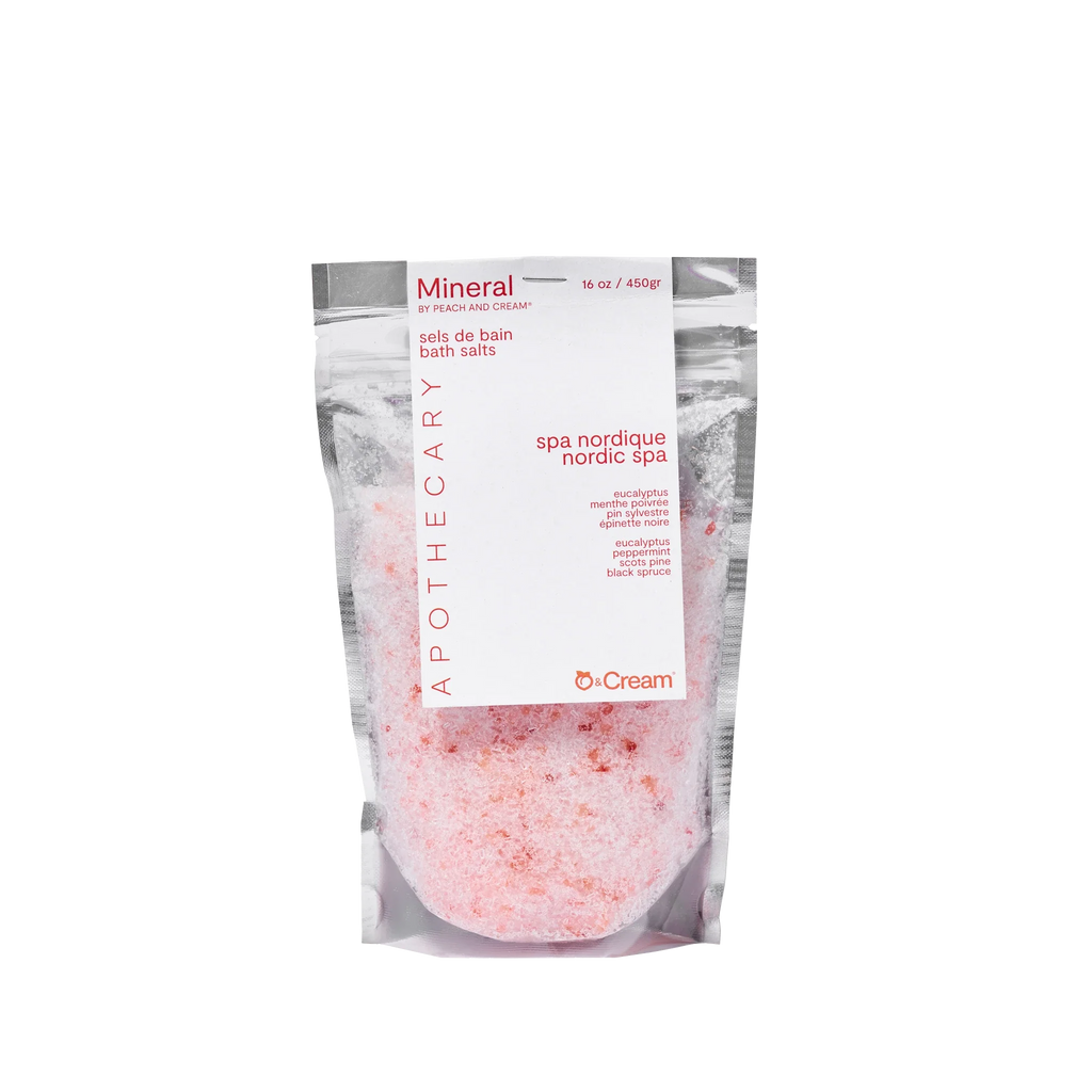 Mineral bath salts from Peach and Cream® in a clear glass jar, showcasing the textured pink and white bath salts.