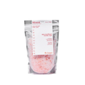 Mineral bath salts from Peach and Cream® in a clear glass jar, showcasing the textured pink and white bath salts.