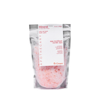 Mineral bath salts from Peach and Cream® in a clear glass jar, showcasing the textured pink and white bath salts.