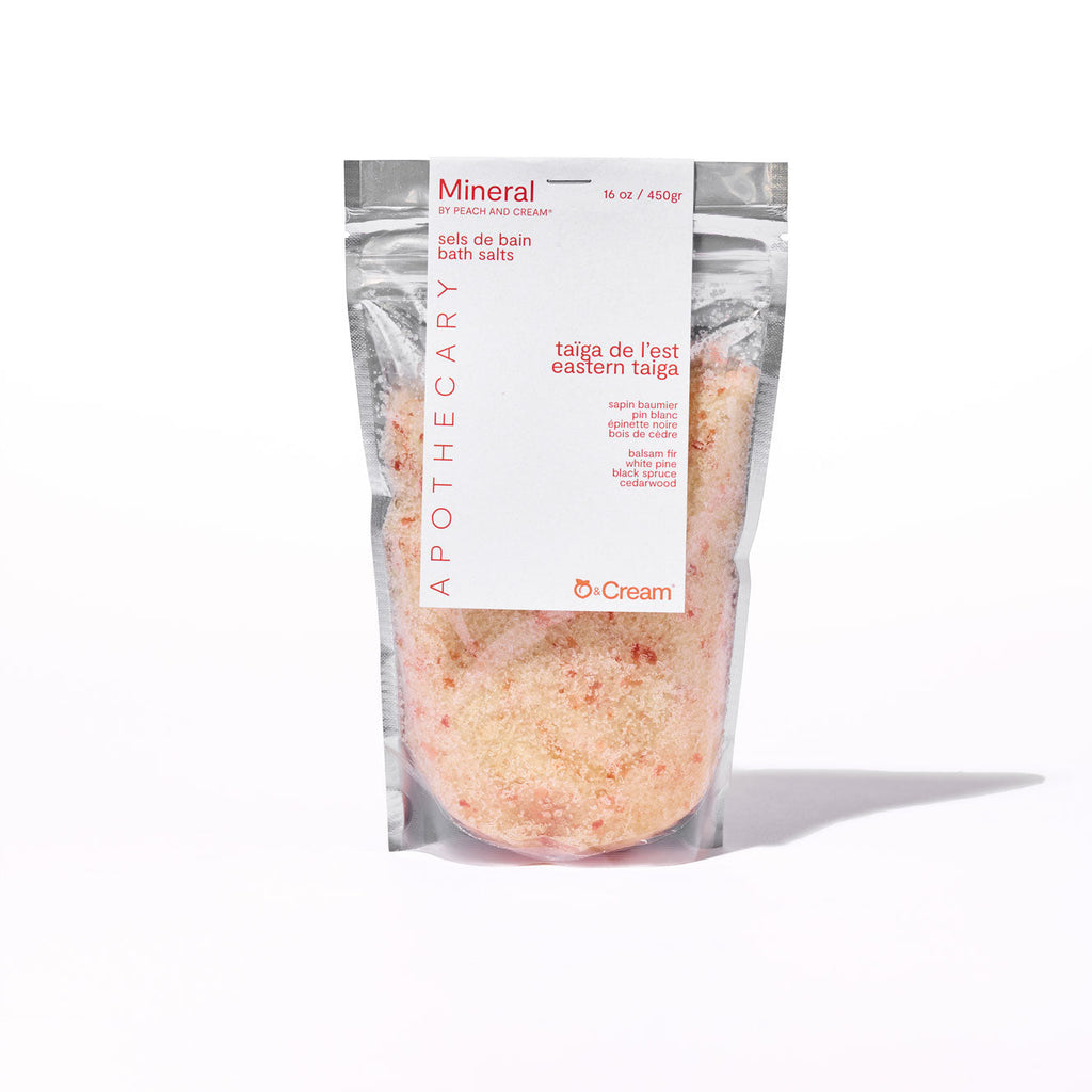 Mineral bath salts from Peach and Cream® in a clear jar with peach and cream-colored packaging, showcasing the product inside.
