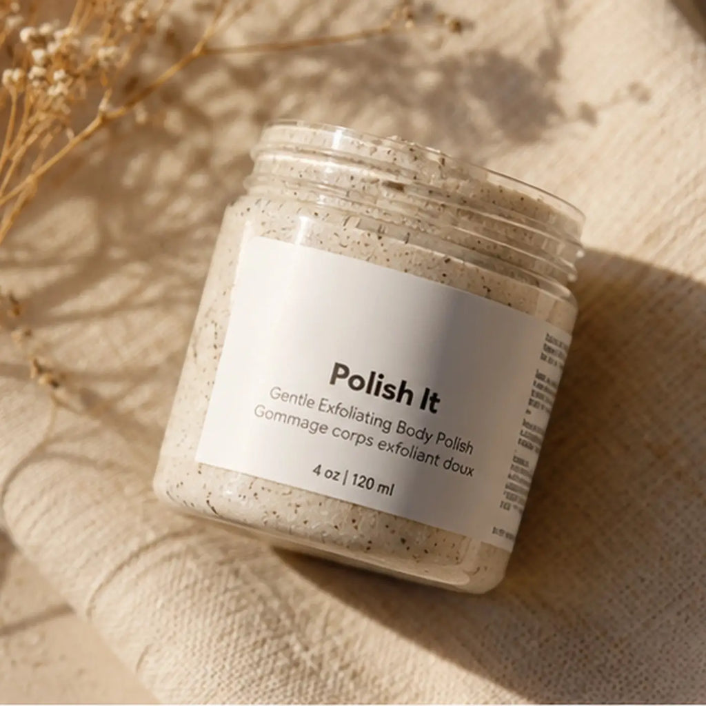 Pure Wash Polish It creamy face scrub in a clear glass jar, showing its gentle exfoliating texture and smooth consistency.