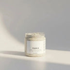 Pure Wash Polish It creamy face scrub in a clear glass jar with light beige exfoliant visible, ideal for gentle skin exfoliation.
