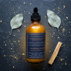 The InnerCandescent Co ROOT & RESTORE grounding botanical hand and body lotion bottle with botanical ingredients and elegant packaging.