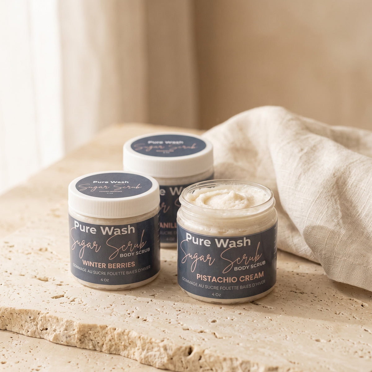 Pure Wash body sugar scrub with exfoliating granules and natural ingredients in a clear jar