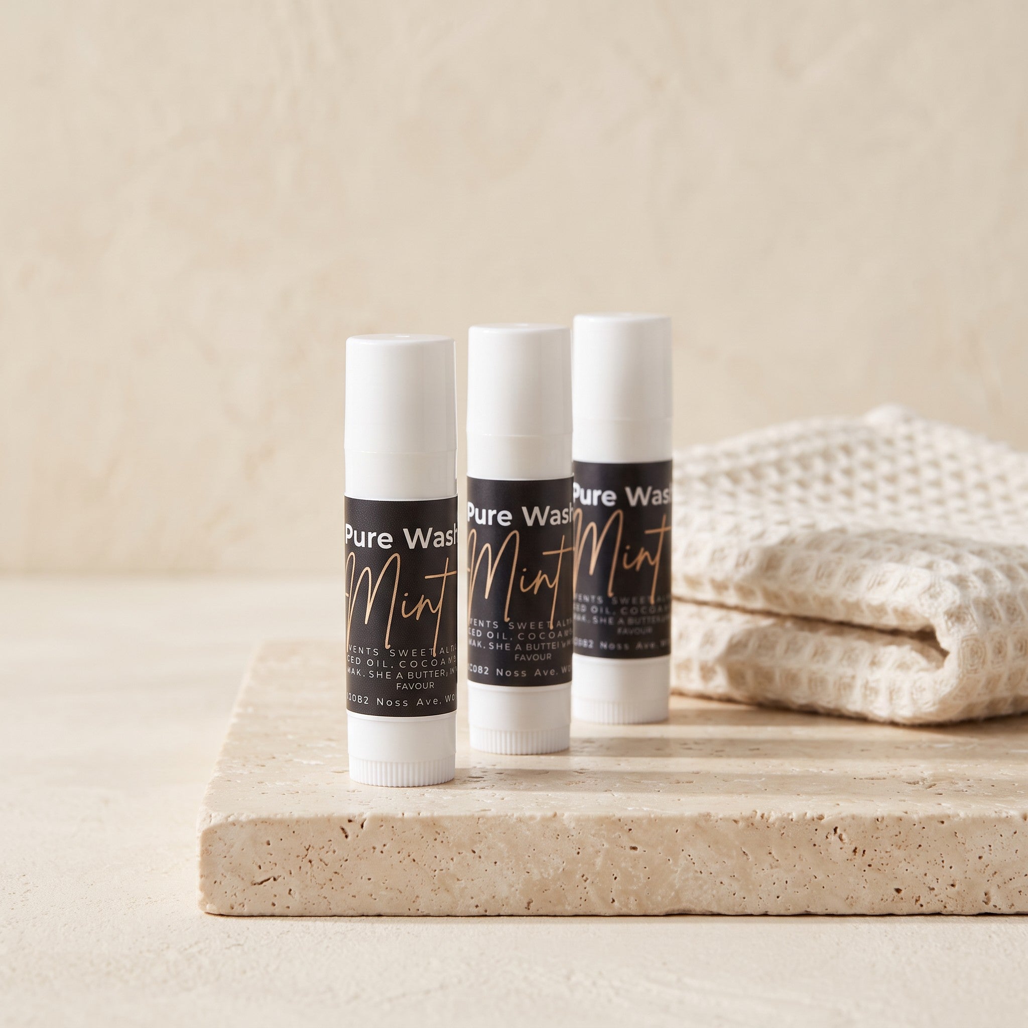 Pure Wash mint lip balm tubes showing smooth, natural lip balm with mint flavor in sleek packaging.