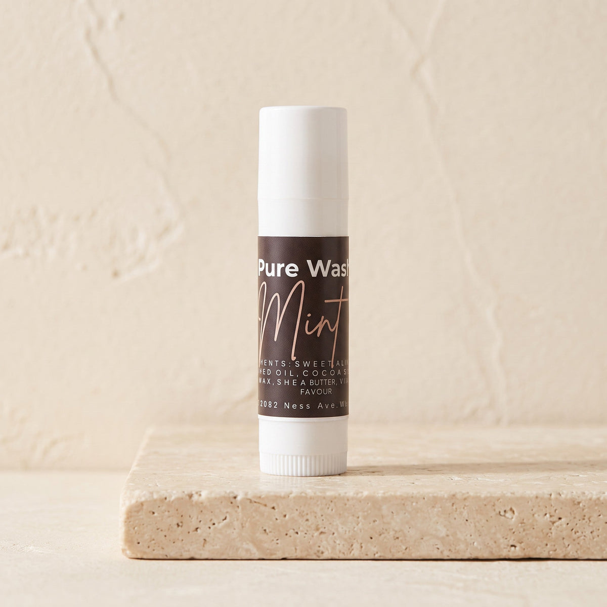 Pure Wash mint lip balm in a small container, featuring a smooth, natural finish and a refreshing mint scent.