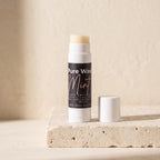 Pure Wash mint lip balm tube with a smooth, shiny surface and a white cap, showing the product label on a plain background.
