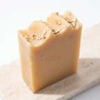 Pure Wash oatmeal milk honey soap bar with creamy texture and natural ingredients, displayed on a neutral background.