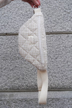 Beige quilted reusable zippered waist bag from Dans Le Sac featuring a compact design and adjustable strap.
