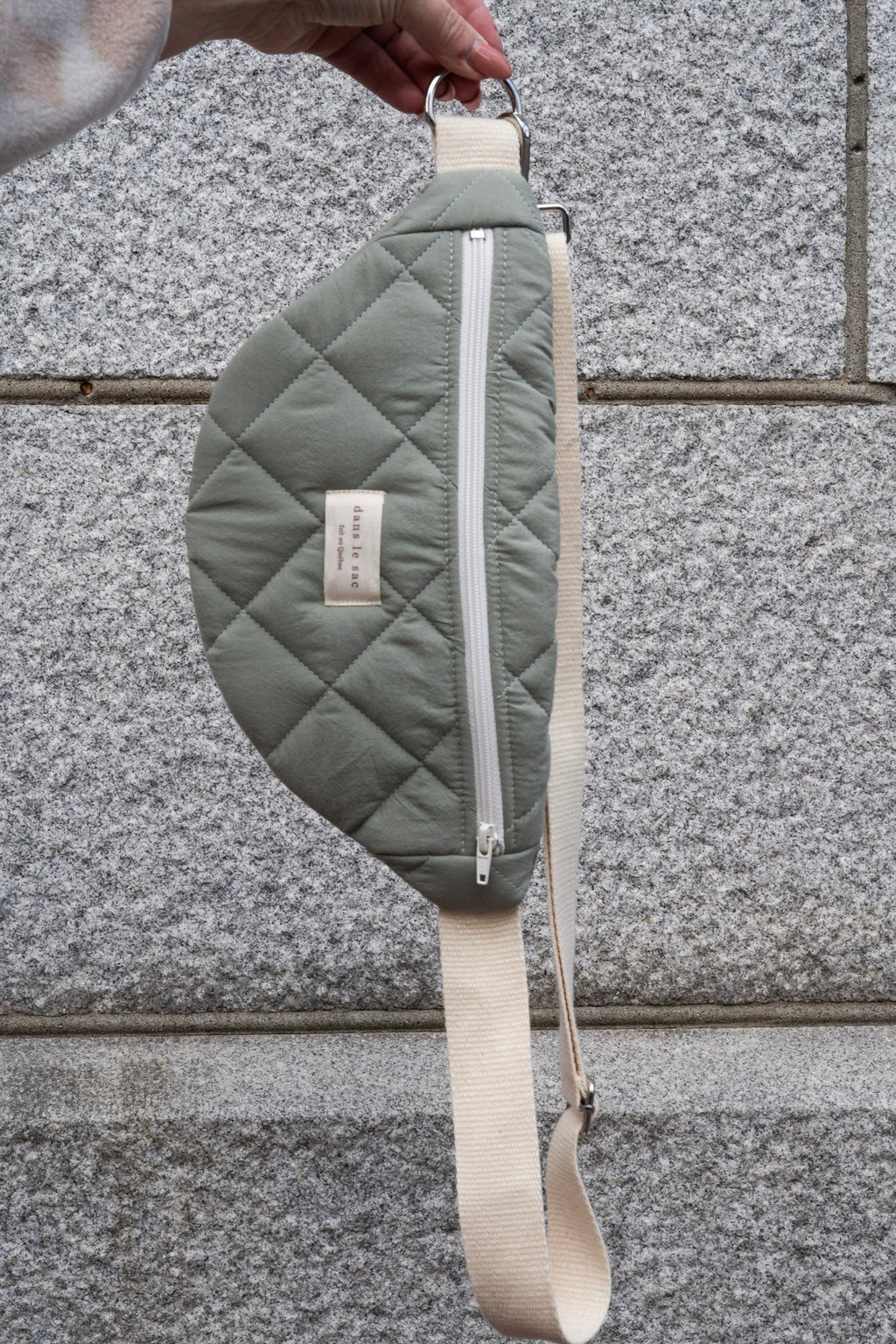 Reusable zippered waist bag from Dans Le Sac in sage green, featuring a compact, practical design for everyday use.
