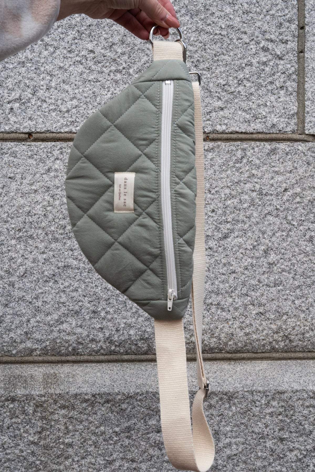 Reusable zippered waist bag from Dans Le Sac in sage green, featuring a compact, practical design for everyday use.