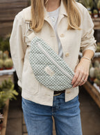 Reusable zippered fanny pack in green plaid fabric from Dans Le Sac, showing its compact design and secure closure.