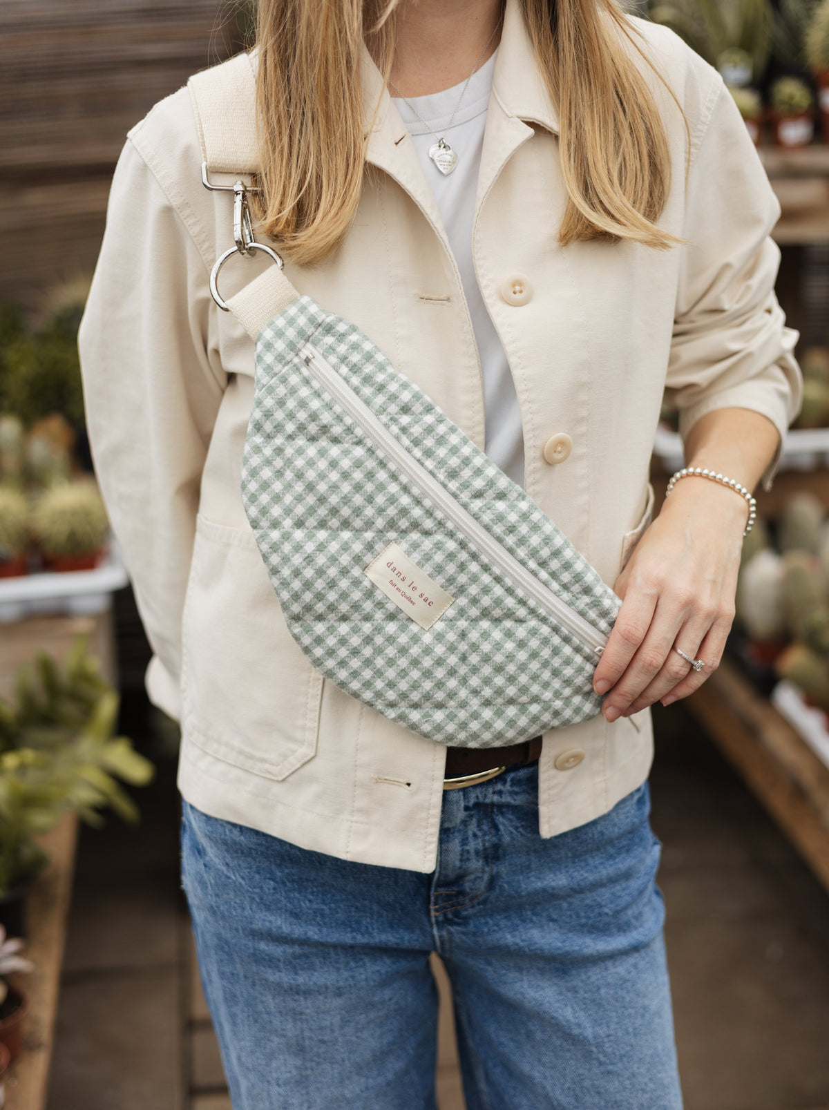 Reusable zippered fanny pack in green plaid fabric from Dans Le Sac, showing its compact design and secure closure.