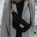 Black reusable zipper pouch from Dans Le Sac, compact banana-shaped bag with secure closure for daily essentials.