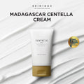 Lakinza K-beauty SKIN1004 Madagascar Centella Cream 75ml jar with white and green packaging, skincare product on a neutral background.