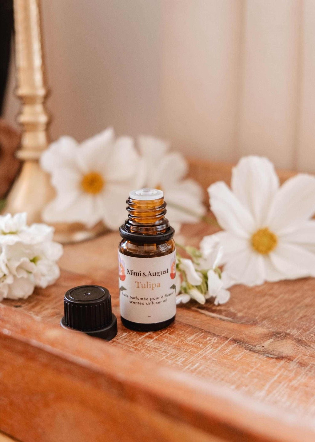 Mimi & August Tulipa scented oil bottle with a floral label, showcasing elegant packaging for aromatic home fragrance.
