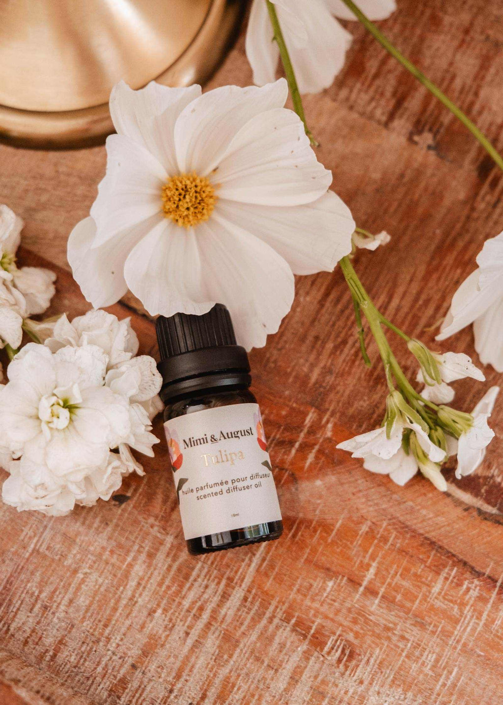 Mimi & August Tulipa scented oil bottle with floral design, showcasing elegant packaging for aromatic essential oils.